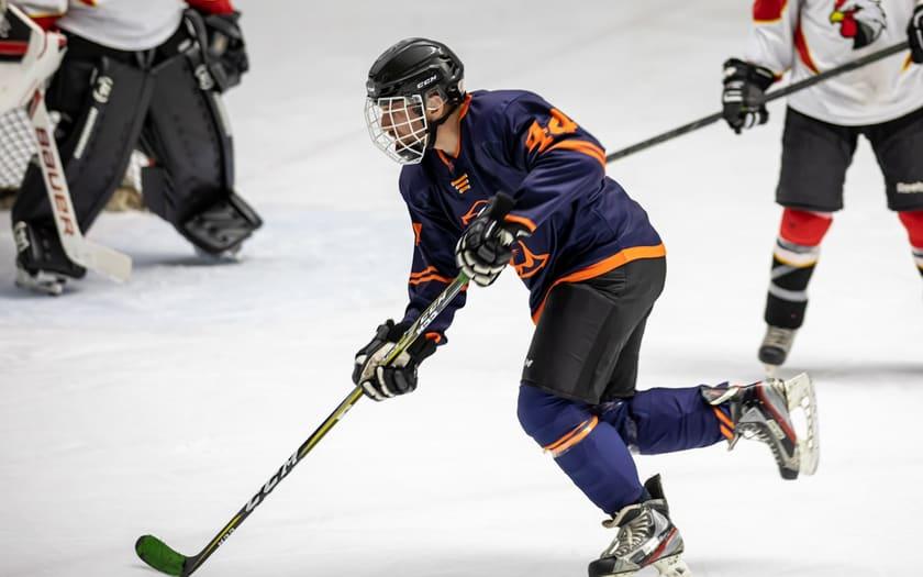 Single player skating on the ice, mid-stride